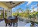 Relaxing balcony with outdoor seating and a view of lush trees at 702 Granada Ave # 7, Venice, FL 34285