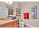 Well-appointed bathroom with wood cabinets and a toilet at 702 Granada Ave # 7, Venice, FL 34285