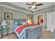 Cozy bedroom with a gray bed frame, coral accents, and tiled floor at 702 Granada Ave # 7, Venice, FL 34285