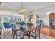 Formal dining room with a large table and chandelier, adjacent to kitchen at 702 Granada Ave # 7, Venice, FL 34285