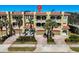 Three-story townhouses with balconies, garages, and palm trees at 702 Granada Ave # 7, Venice, FL 34285