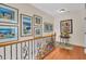 Upper hallway with hardwood floors and art pieces at 702 Granada Ave # 7, Venice, FL 34285