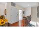 Upstairs hallway with hardwood floors and access to bedrooms at 702 Granada Ave # 7, Venice, FL 34285