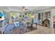 Bright living room featuring a comfy sofa and a large TV at 702 Granada Ave # 7, Venice, FL 34285