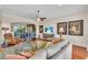 Spacious living room with hardwood floors, comfortable furniture, and large TV at 702 Granada Ave # 7, Venice, FL 34285