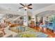 Open concept living area with hardwood floors, a staircase, and multiple seating areas at 702 Granada Ave # 7, Venice, FL 34285