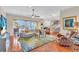 Spacious living room with hardwood floors, large windows, and comfortable seating at 702 Granada Ave # 7, Venice, FL 34285