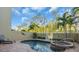 Relaxing pool and spa area with patio furniture and lush landscaping at 702 Granada Ave # 7, Venice, FL 34285