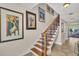 Elegant wooden staircase with wrought iron railing at 702 Granada Ave # 7, Venice, FL 34285