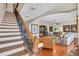 Elegant staircase leading to living area with hardwood floors at 702 Granada Ave # 7, Venice, FL 34285