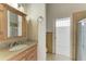 Bathroom with granite vanity, tiled floors, and shower at 7023 Chickasaw Bayou Rd, Bradenton, FL 34203