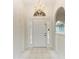 Bright and airy foyer with a chandelier and tiled floor at 7023 Chickasaw Bayou Rd, Bradenton, FL 34203