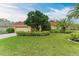 House exterior showcasing landscaping and a large grassy yard at 7023 Chickasaw Bayou Rd, Bradenton, FL 34203