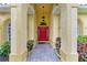 Inviting entryway with a red door and arched columns at 7023 Chickasaw Bayou Rd, Bradenton, FL 34203