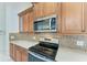 Kitchen with stainless steel appliances and wood cabinets at 7023 Chickasaw Bayou Rd, Bradenton, FL 34203