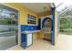Outdoor kitchen with blue tile and stainless steel grill at 7023 Chickasaw Bayou Rd, Bradenton, FL 34203
