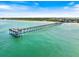 Aerial shot of a long pier stretching along a sandy beach, offering recreational opportunities and ocean views at 752 White Pine Tree Rd # 108, Venice, FL 34285