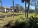 Serene condo backyard featuring a scenic pond view and well-maintained greenery at 752 White Pine Tree Rd # 108, Venice, FL 34285