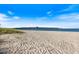 Expansive beach view featuring a long pier stretching into the blue ocean under a bright, sunny sky at 752 White Pine Tree Rd # 108, Venice, FL 34285