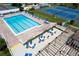 Community pool and patio area with multiple seating areas at 752 White Pine Tree Rd # 108, Venice, FL 34285