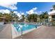 Large community pool surrounded by palm trees and lounge chairs for relaxation at 752 White Pine Tree Rd # 108, Venice, FL 34285