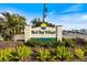 Welcoming Bird Bay Village community sign amidst vibrant landscaping at 752 White Pine Tree Rd # 108, Venice, FL 34285