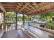 Poolside gazebo offers a shaded retreat with picnic tables and serene views at 752 White Pine Tree Rd # 108, Venice, FL 34285
