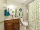 Clean bathroom with a shower and wood vanity at 806 Capri Isles Blvd # 109, Venice, FL 34292