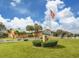 Capri Isles clubhouse with golf cart parking at 806 Capri Isles Blvd # 109, Venice, FL 34292