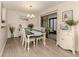 Bright dining room with hardwood floors and access to a patio at 806 Capri Isles Blvd # 109, Venice, FL 34292