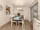 Charming dining room featuring a farmhouse table and hardwood floors at 806 Capri Isles Blvd # 109, Venice, FL 34292
