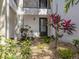 Condo entry with landscaping and a gray door at 806 Capri Isles Blvd # 109, Venice, FL 34292