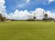 Expansive grassy golf course with palm trees at 806 Capri Isles Blvd # 109, Venice, FL 34292