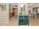 Kitchen with wood cabinets, white appliances, and teal accents at 806 Capri Isles Blvd # 109, Venice, FL 34292
