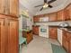 Kitchen with wood cabinets, granite counters, and white appliances at 806 Capri Isles Blvd # 109, Venice, FL 34292