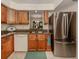 Kitchen with stainless steel appliances and wood cabinets at 806 Capri Isles Blvd # 109, Venice, FL 34292