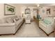 Living room with light beige couch and striped armchairs at 806 Capri Isles Blvd # 109, Venice, FL 34292