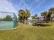 Community tennis court with surrounding landscaping at 806 Capri Isles Blvd # 109, Venice, FL 34292