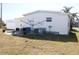 Home's backyard with clothesline and patio at 808 S Green Cir, Venice, FL 34285