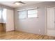 Bedroom with wood floor,door and window with blinds at 808 S Green Cir, Venice, FL 34285
