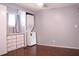 Bedroom with washer, dryer, built-in storage, and wood floors at 808 S Green Cir, Venice, FL 34285
