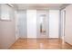 Bedroom with mirrored closet doors and wood flooring at 808 S Green Cir, Venice, FL 34285