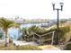 Steps leading down to a canal with boats and lush landscaping at 808 S Green Cir, Venice, FL 34285