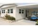 Single-story home with covered carport and golf cart at 808 S Green Cir, Venice, FL 34285