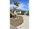 Single-story home with covered carport and landscaping at 808 S Green Cir, Venice, FL 34285