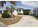 Single-story home with covered carport, landscaping, and paved driveway at 808 S Green Cir, Venice, FL 34285