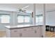 Bright kitchen features white cabinets, stainless steel appliances, and a breakfast bar at 808 S Green Cir, Venice, FL 34285