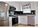 Modern kitchen with stainless steel appliances and a breakfast bar at 808 S Green Cir, Venice, FL 34285