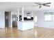 Open concept living area with light wood floors and breakfast bar at 808 S Green Cir, Venice, FL 34285