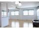Bright living room with light walls, ceiling fan, and laminate flooring at 808 S Green Cir, Venice, FL 34285